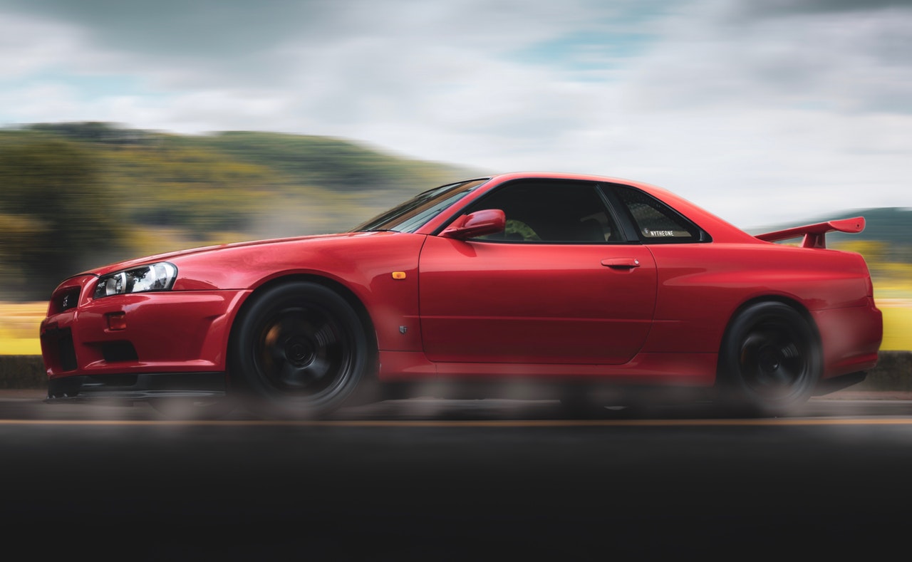 a read car speeding on the road