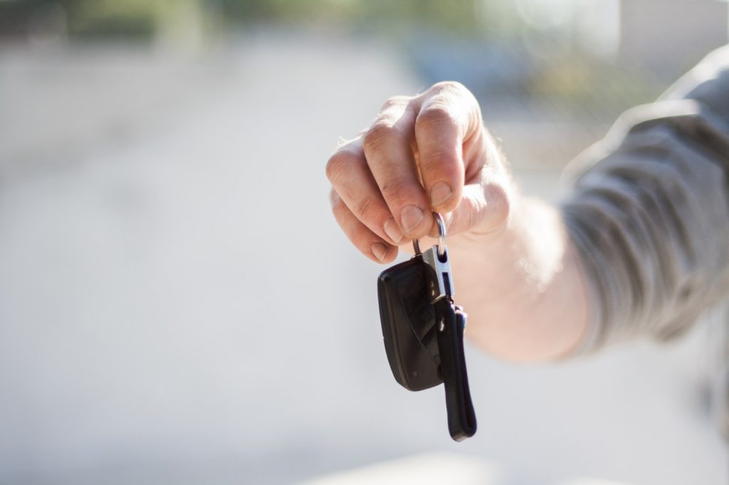 a man holding a car key